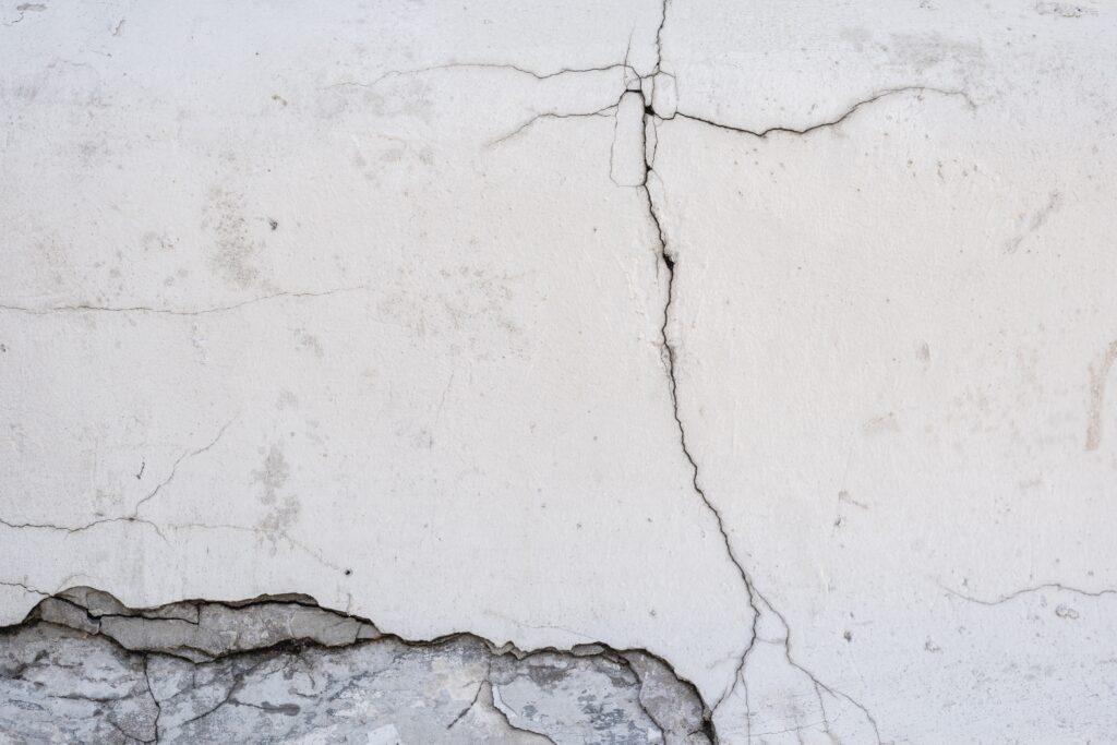 cracked and breaking concrete wall