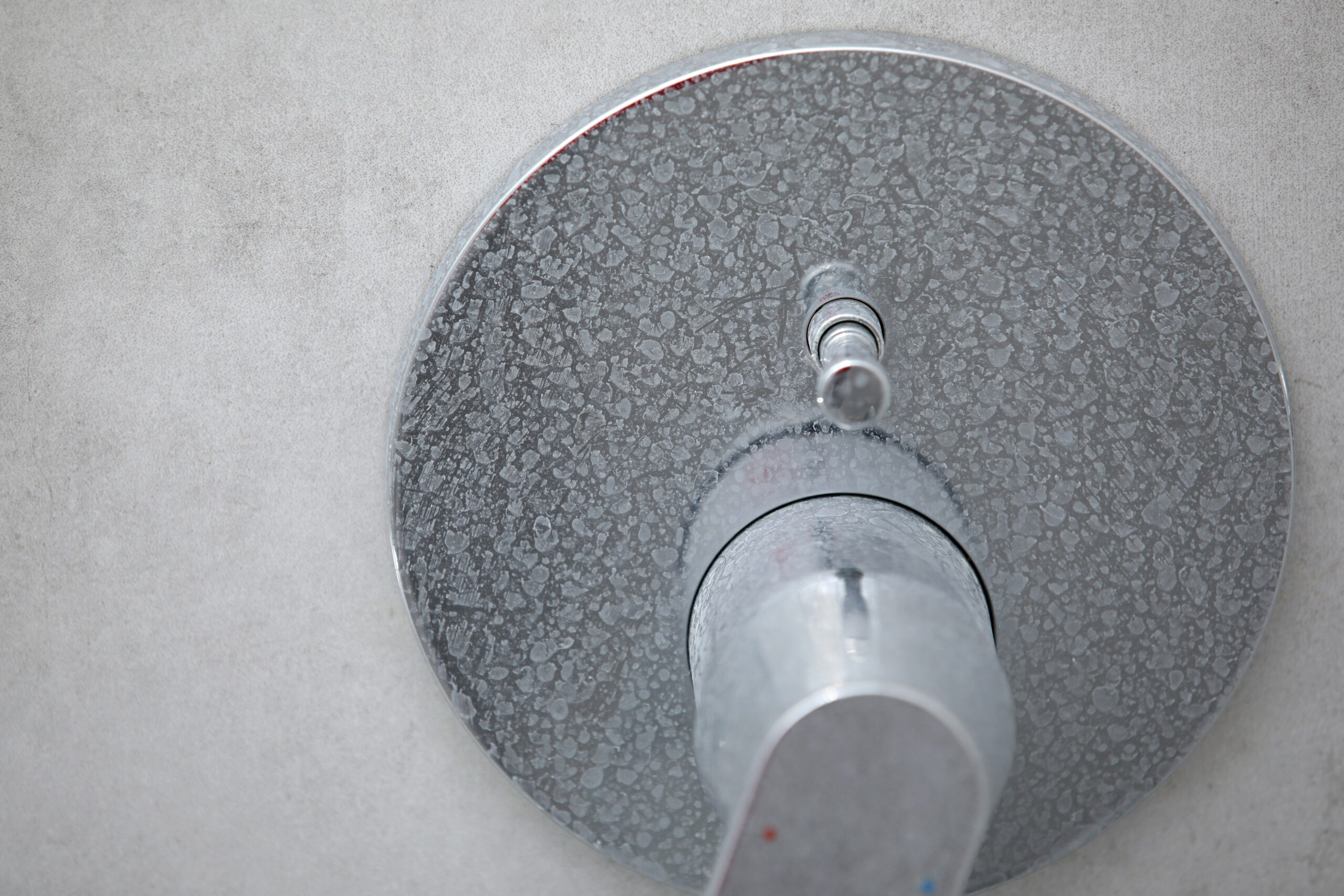 shower faucet with limescale on it from hard water